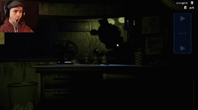 Man Wearing Headphones Playing Video Game At Night GIF