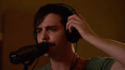 Man Wearing Headphones Singing Into Microphone GIF