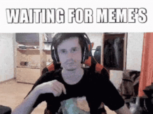Man Wearing Headphones Sitting At Desk Waiting For Memes GIF