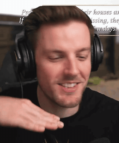 Man Wearing Headphones Smiling In Front Of Sign People's Houses Are Missing GIF