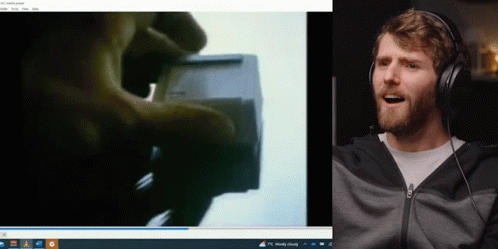 Man Wearing Headphones Smiling Next To Computer GIF