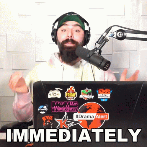 Man Wearing Headphones Stands In Front Of Laptop Immediately GIF