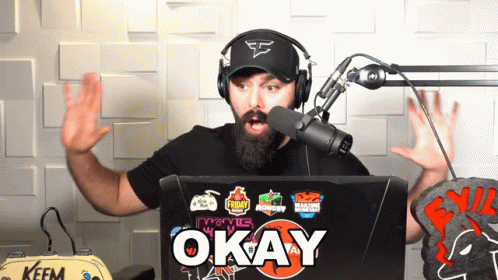 Man Wearing Headphones Stands In Front Of Laptop Says Okay GIF