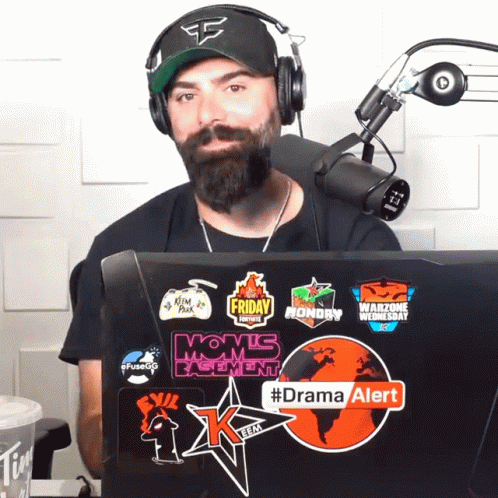 Man Wearing Headphones Stands In Front Of Microphone With #Dramaalert Sticker GIF