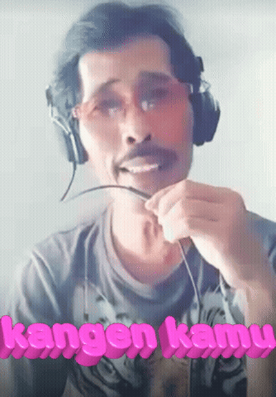 Man Wearing Headphones With Kangen Kamu In Pink Letters GIF