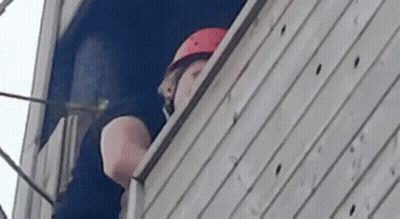 Man Wearing Helmet Looking Out Window GIF