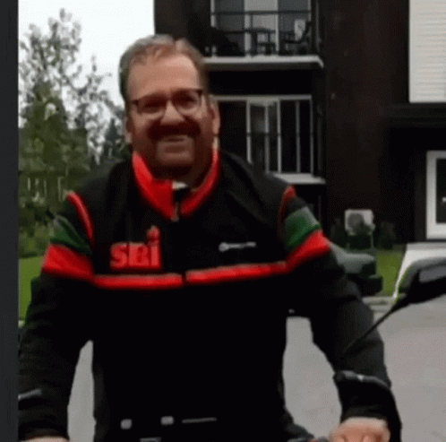 Man Wearing Jacket That Says Sri Riding Motorcycle GIF