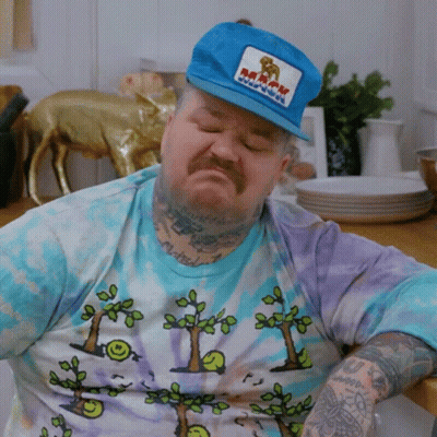 Man Wearing Kaboom Hat Sitting GIF
