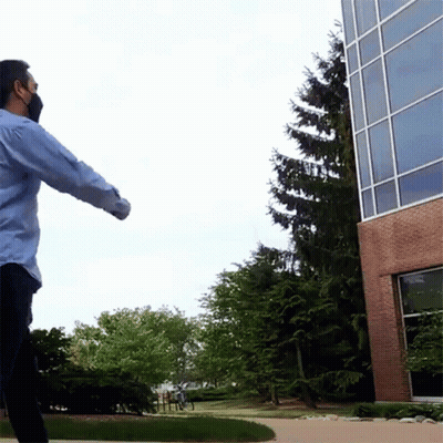 Man Wearing Mask In Front Of Building GIF