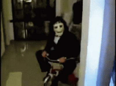 Man Wearing Mask Riding Bike GIF