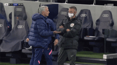 Man Wearing Mask Shakes Hands With Another Man In Front Of Audi Seats GIF