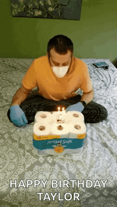 Man Wearing Mask Sitting With Toilet Paper Cake GIF