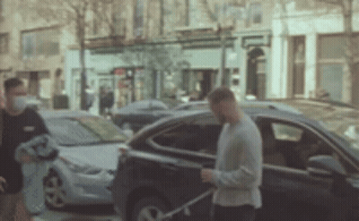 Man Wearing Mask Walking Towards Car GIF
