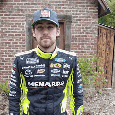 Man Wearing Menards Racing Suit At Brick Building GIF