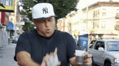 Man Wearing New York Yankees Hat Holding Bag Of Money GIF
