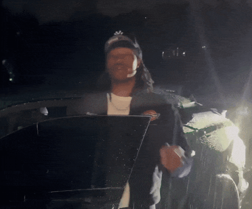 Man Wearing NY Hat Standing In Front Of Car GIF