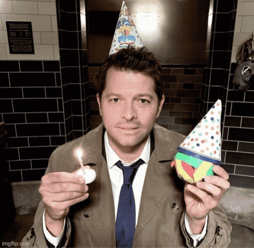 Man Wearing Party Hat Holding Candle GIF
