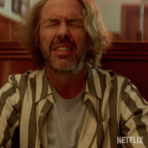 Man Wearing Striped Shirt With Netflix Logo GIF