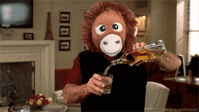 Man Wearing Stuffed Monkey Mask Pouring Liquor GIF