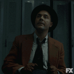 Man Wearing Suit Ear Plugs GIF