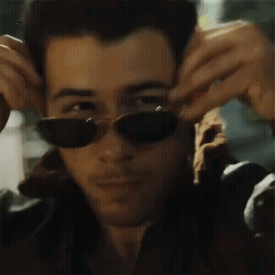 Man Wearing Sunglasses Adjusting Jacket GIF