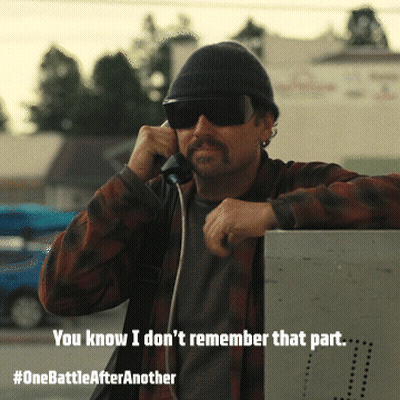 Man Wearing Sunglasses And Beanie Talking On Phone GIF