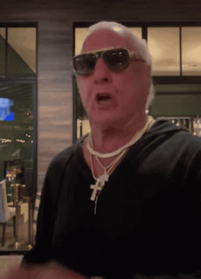 Man Wearing Sunglasses And Cross Necklace GIF