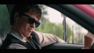 Man Wearing Sunglasses And Earphones Driving GIF