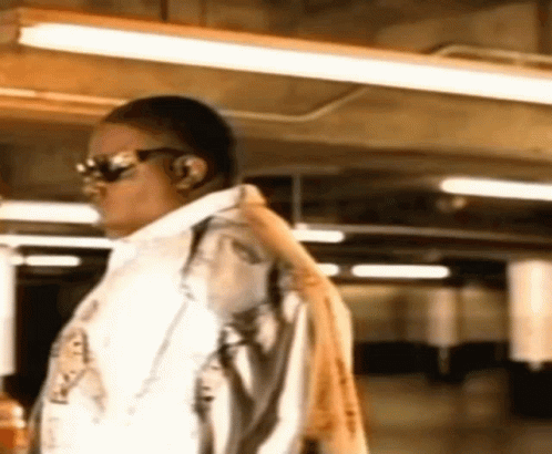 Man Wearing Sunglasses And Headphones Standing In Room GIF