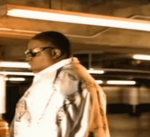 Man Wearing Sunglasses And Jacket With Backpack GIF