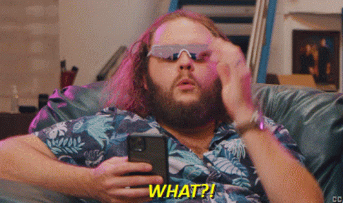 Man Wearing Sunglasses Holding Cell Phone Saying What GIF