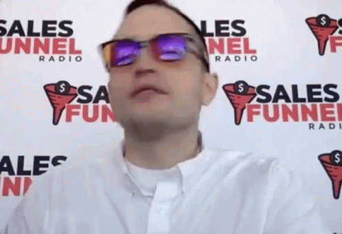 Man Wearing Sunglasses In Front Of Radio Sign GIF