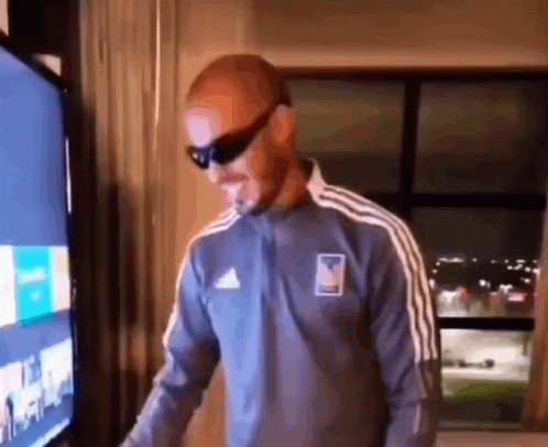Man Wearing Sunglasses In Front Of TV GIF