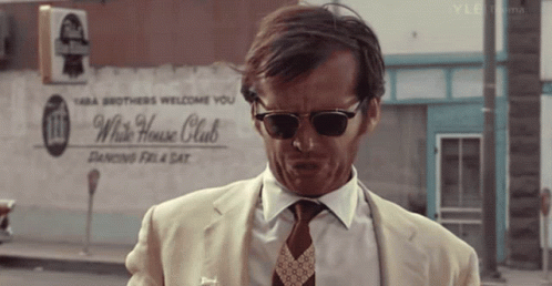 Man Wearing Sunglasses In Front Of White House Club Sign GIF