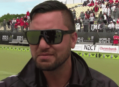 Man Wearing Sunglasses In Front Of World Bowls Sign GIF
