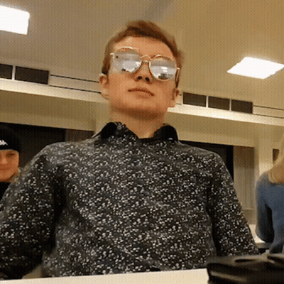 Man Wearing Sunglasses Sitting At Table GIF
