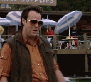Man Wearing Sunglasses Standing In Front Of Supplies Sign GIF