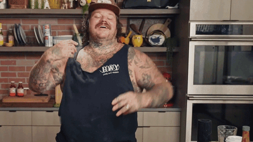 Man Wearing Tank Top That Says Legacy Dancing In Kitchen GIF