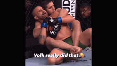 Man Wearing UFC Glove Covers Face In Dark GIF