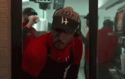 Man Wearing Visor And Headphones In Restaurant Doorway GIF