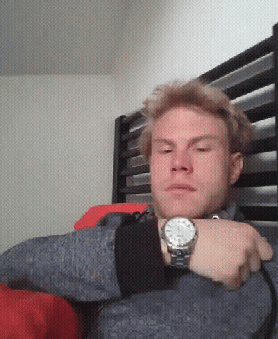 Man Wearing Watch Sitting In Bed GIF