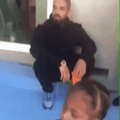 Man Wearing Watch Sitting On Blue Surface GIF