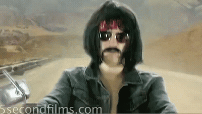Man Wearing Wig And Sunglasses Riding Motorcycle GIF