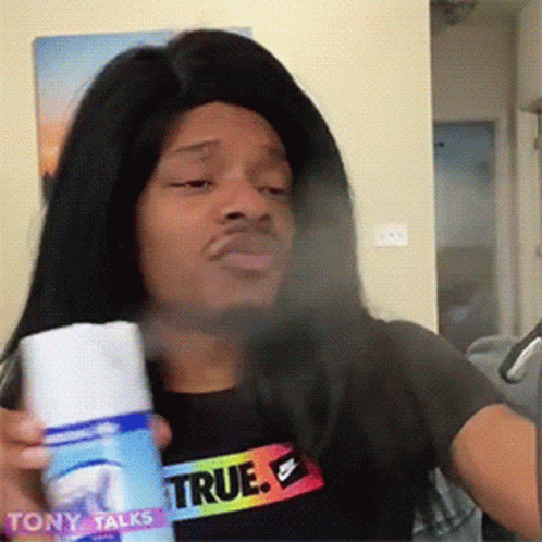 Man Wearing Wig And True Shirt Spraying Face GIF