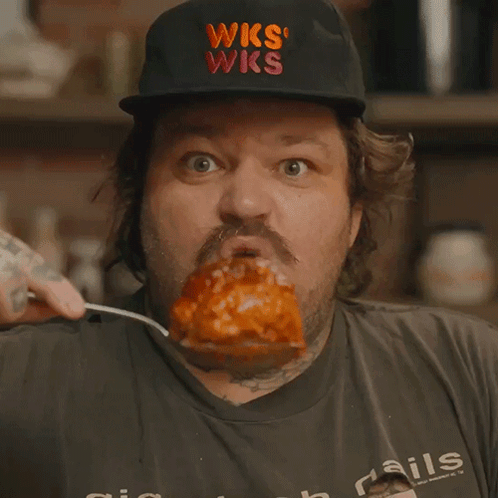 Man Wearing WKS Hat Eating Meat GIF