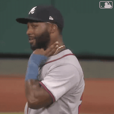 Man Wearing Yankees Hat Touching Neck GIF