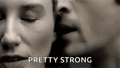 Man Whispering And Kissing Woman On Cheek GIF