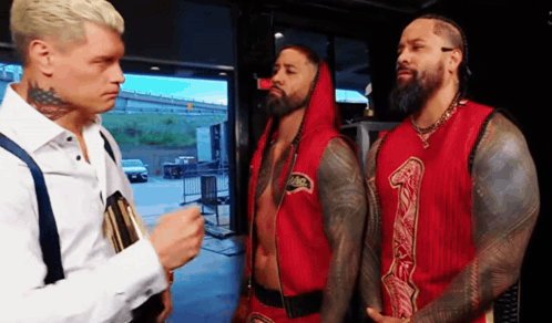 Man White Shirt Talking Two Red Shirts 1 GIF