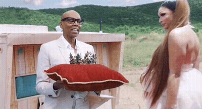 Man White Suit Holding Red Pillow Gold Trim GIF