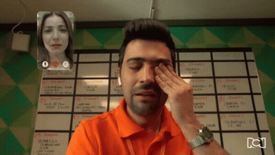 Man Wiping Eyes On Video Call With Woman And Semana Calendar GIF